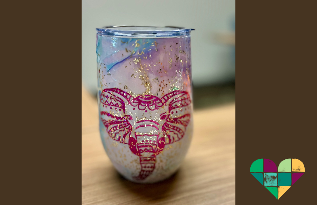 One of the craft creations made for the Mercy Marketplace: a tumbler, with the face of an elephant and glitter.